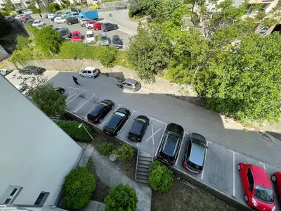 an aerial view of a parking lot with cars parked at Aquarium Apartment Kotor in Kotor