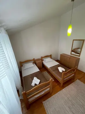 a room with two beds and a mirror at Aquarium Apartment Kotor in Kotor