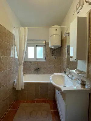 a bathroom with a sink and a bath tub at Aquarium Apartment Kotor in Kotor