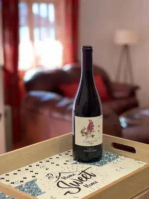 a bottle of wine sitting on top of a wooden tray at Aquarium Apartment Kotor in Kotor
