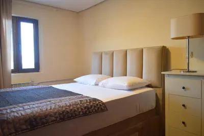a bedroom with a bed and a window at Ambassador Apartments in Petrovac na Moru
