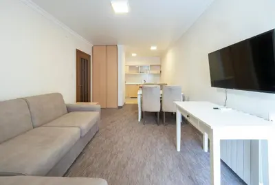 a living room with a couch and a table at Ambassador Apartments in Petrovac na Moru