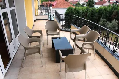 a patio with chairs and a table on a balcony at Hotel Crnogorska Kuća in Podgorica