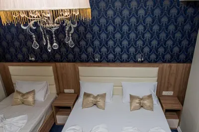 a bedroom with two beds with bow ties on them at Hotel Crnogorska Kuća in Podgorica