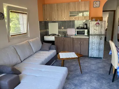 a living room with a couch and a kitchen at Bay Mola Aparts in Kotor