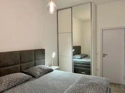 a bedroom with a bed and a large mirror at Kaljevic 13 in Bar