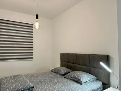 a bedroom with a bed with two pillows at Kaljevic 13 in Bar