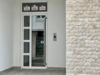 a glass door to a building with two signs on it at Kaljevic 13 in Bar