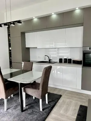 a kitchen with a table and chairs and a sink at Kaljevic 13 in Bar