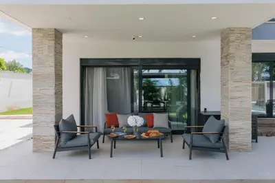 a patio with two chairs and a table at Villa Garden with Private Outdoor Pool in Kotor