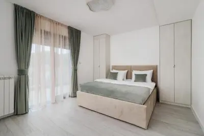 a bedroom with a bed and a large window at Villa Garden with Private Outdoor Pool in Kotor