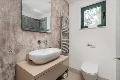 a bathroom with a white sink and a mirror at Villa Garden with Private Outdoor Pool in Kotor