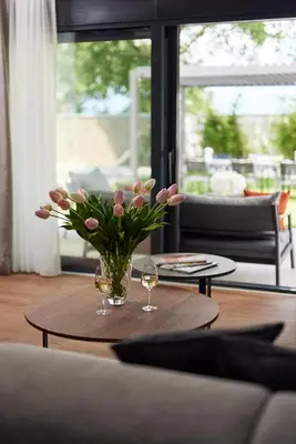 a vase of flowers on a table in a living room at Villa Garden with Private Outdoor Pool in Kotor