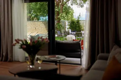 a living room with a vase of flowers on a table at Villa Garden with Private Outdoor Pool in Kotor