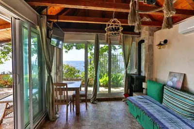 a living room with a couch and a table at DreamSea Apartment in Utjeha