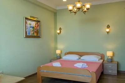 a bedroom with a bed with two towels on it at DreamSea Apartment in Utjeha