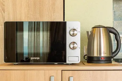 a microwave sitting on a counter next to a kettle at DreamSea Apartment in Utjeha