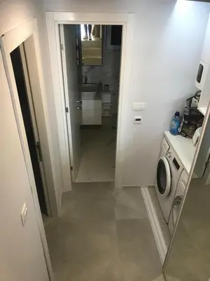 a bathroom with a sink and a washing machine at Lux Beach House M in Pržno