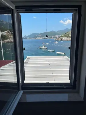 a window with a view of a large body of water at Lux Beach House M in Pržno