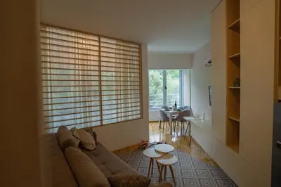 a living room with a couch and a table at Studio apartment Sunrise Rafailovici in Budva