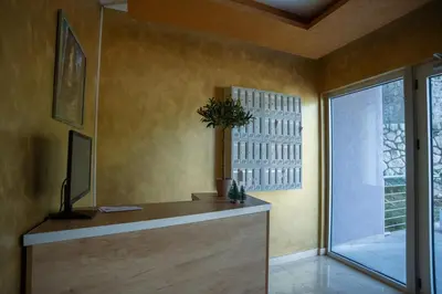 a room with a desk and a window with a potted plant at Studio apartment Sunrise Rafailovici in Budva