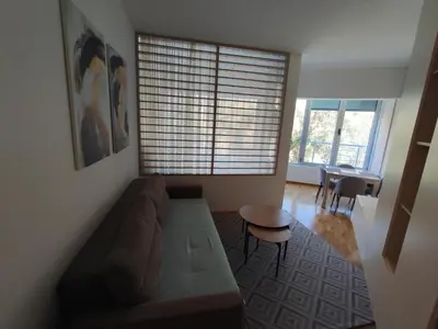 a living room with a couch and a table at Studio apartment Sunrise Rafailovici in Budva