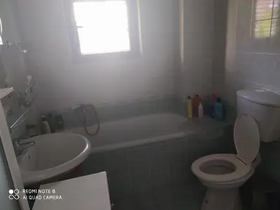 a bathroom with a toilet and a tub and a sink at Apartman Potkošljun in Budva