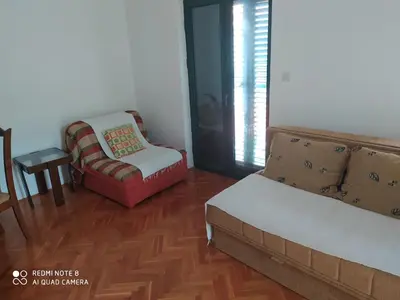 a living room with a couch and a chair at Apartman Potkošljun in Budva
