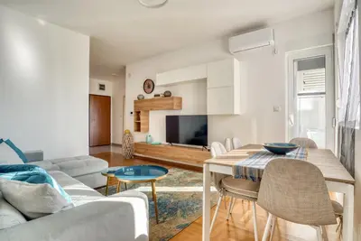 a living room with a table and a couch at Baby Blue Apartments in Budva