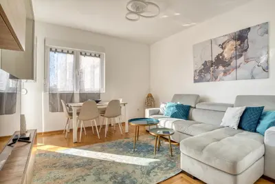 a living room with a couch and a table at Baby Blue Apartments in Budva