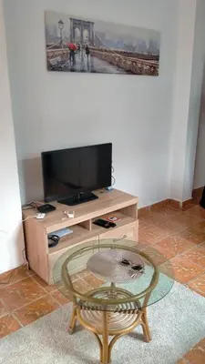 a living room with a tv and a coffee table at Extra lokacija!!!!! in Sutomore