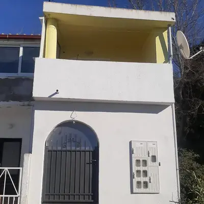a white building with a gate in front of it at Extra lokacija!!!!! in Sutomore
