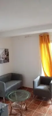 a living room with two couches and a glass table at Extra lokacija!!!!! in Sutomore
