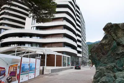 a building on a street in front of a building at Apartment MARIA Lux in Rafailovici