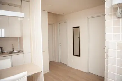 a kitchen with white walls and a mirror on the wall at Apartment MARIA Lux in Rafailovici