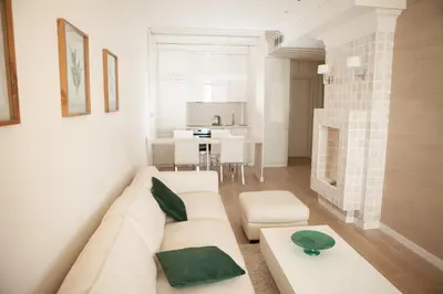 a living room with a white couch and a table at Apartment MARIA Lux in Rafailovici
