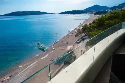 a view of a beach and the ocean from a building at Apartment MARIA Lux in Rafailovici
