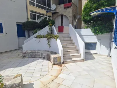 a building with a staircase with flowers on it at Apartman - Fontana (Rafailovici) in Rafailovici
