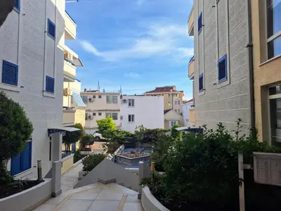 a view of a courtyard between two buildings at Apartman - Fontana (Rafailovici) in Rafailovici