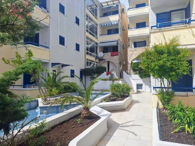 a courtyard in a building with a palm tree at Apartman - Fontana (Rafailovici) in Rafailovici