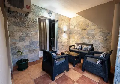 a living room with two chairs and a table at APARTMANI VUKADINOVIC LUX in Budva