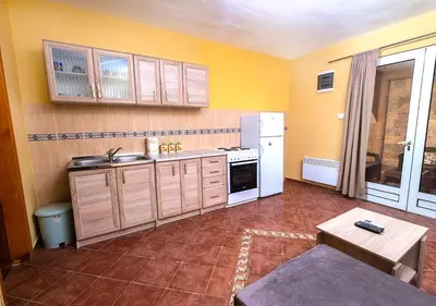 a kitchen with yellow walls and a white refrigerator at APARTMANI VUKADINOVIC LUX in Budva