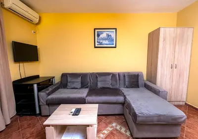 a living room with a couch and a table at APARTMANI VUKADINOVIC LUX in Budva