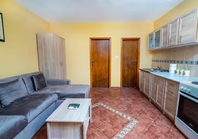 a living room with a couch and a table at APARTMANI VUKADINOVIC LUX in Budva