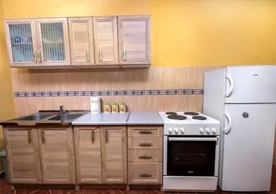 a kitchen with a stove and a white refrigerator at APARTMANI VUKADINOVIC LUX in Budva