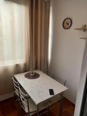 a table and chairs in a room with a window at Studio Dina in Becici