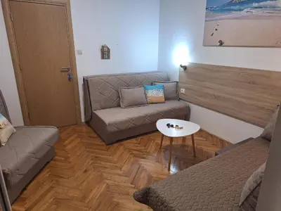 a living room with a couch and a coffee table at Studio Dina in Becici