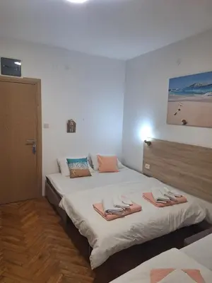 a bedroom with two beds with towels on them at Studio Dina in Becici