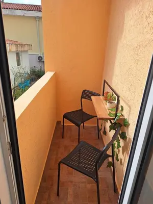 a small balcony with two chairs and a table at Studio Dina in Becici