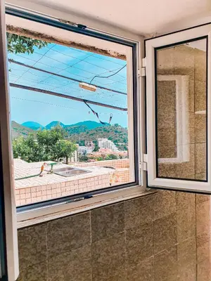 a large window in a bathroom with a view at Apartman Lana in Petrovac na Moru